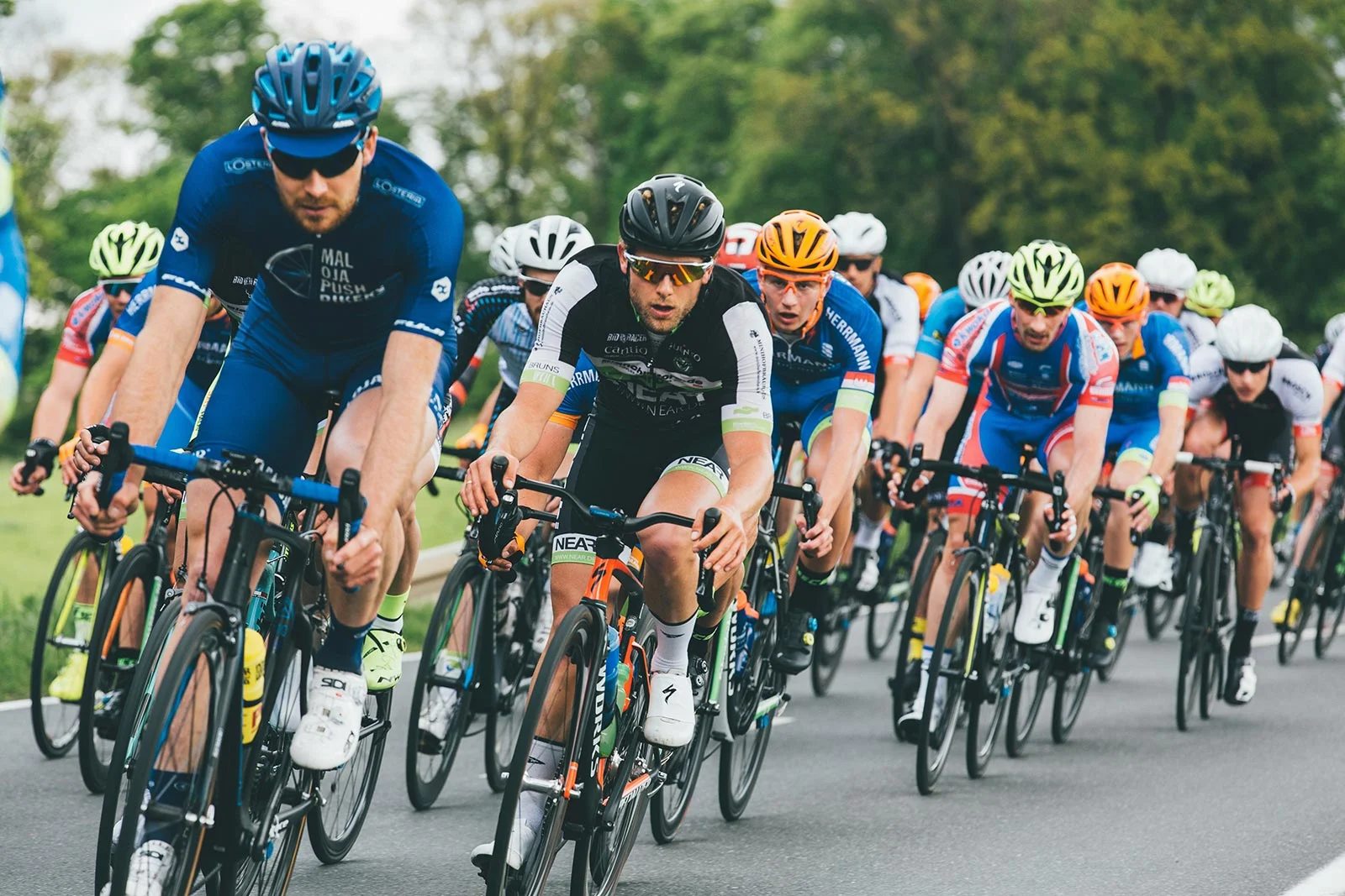 peloton cyclists racing road competition