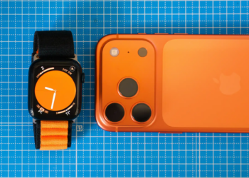 Minimalist setup featuring an orange-themed smartphone and smartwatch on a blue grid background