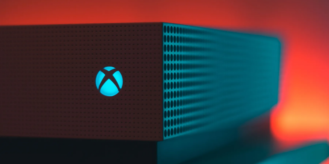 Close-up of an illuminated gaming console with a red and blue light aura