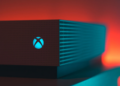 Close-up of an illuminated gaming console with a red and blue light aura