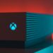 Close-up of an illuminated gaming console with a red and blue light aura