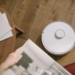 A sleek robot vacuum cleaner operating on a wooden floor, symbolizing modern home technology