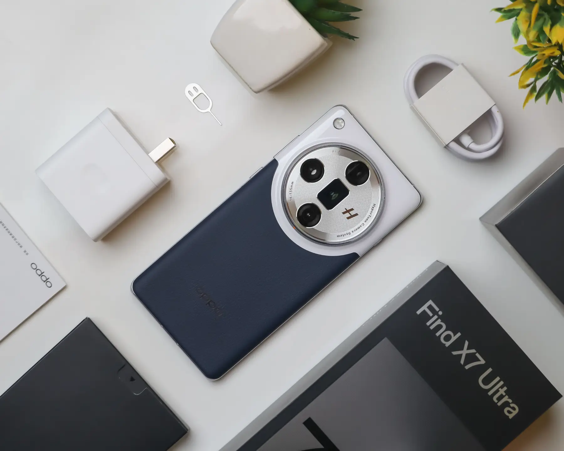 Flat lay of Oppo Find X7 Ultra smartphone with accessories on white background