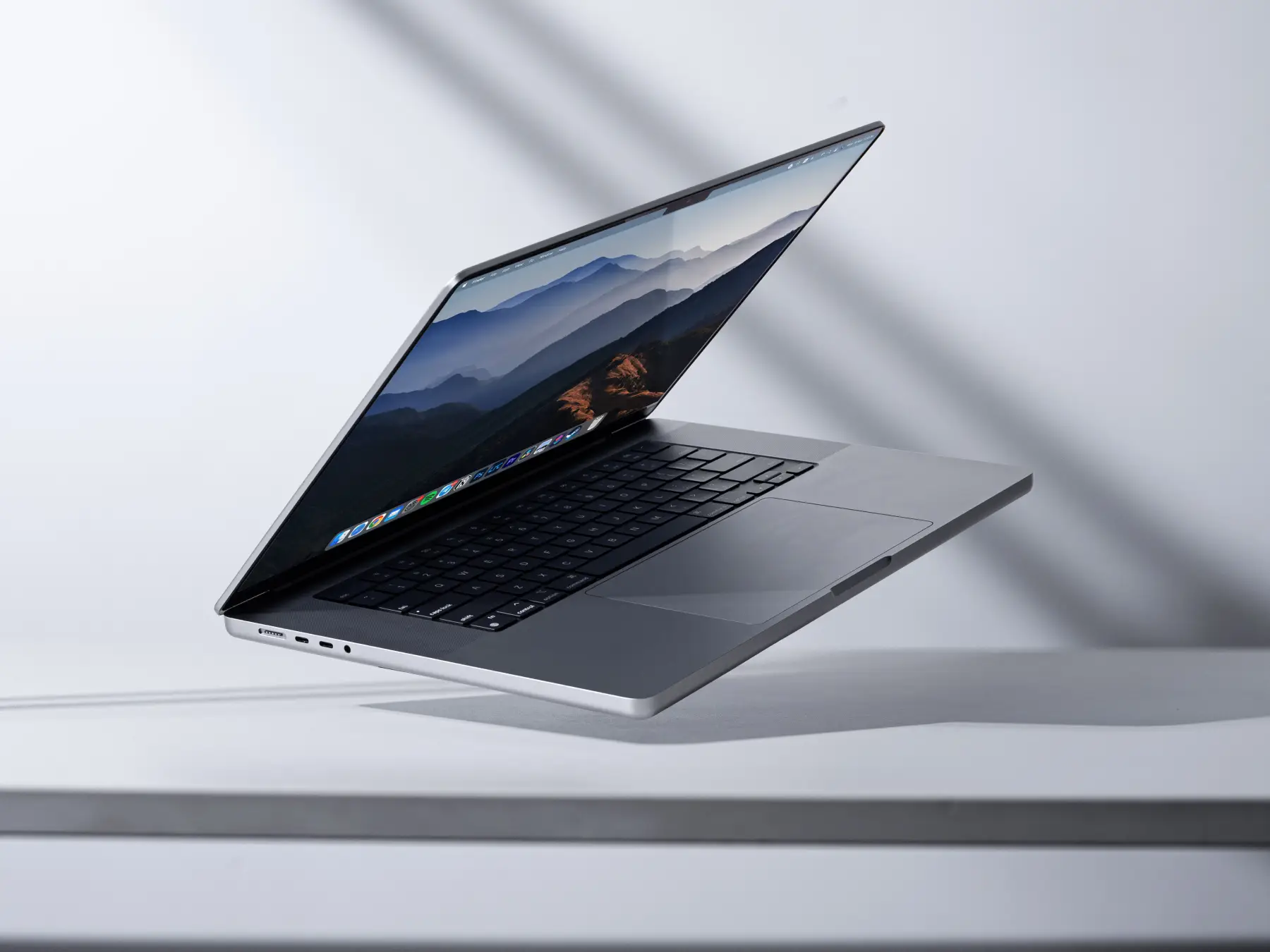 Modern laptop levitating in a minimalist studio setting. Perfect for technology themes
