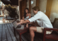 man and woman laptop on verandah