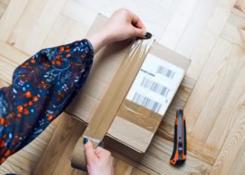 woman preparing online order packing parcel