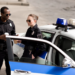 two police officers chatting near patrol