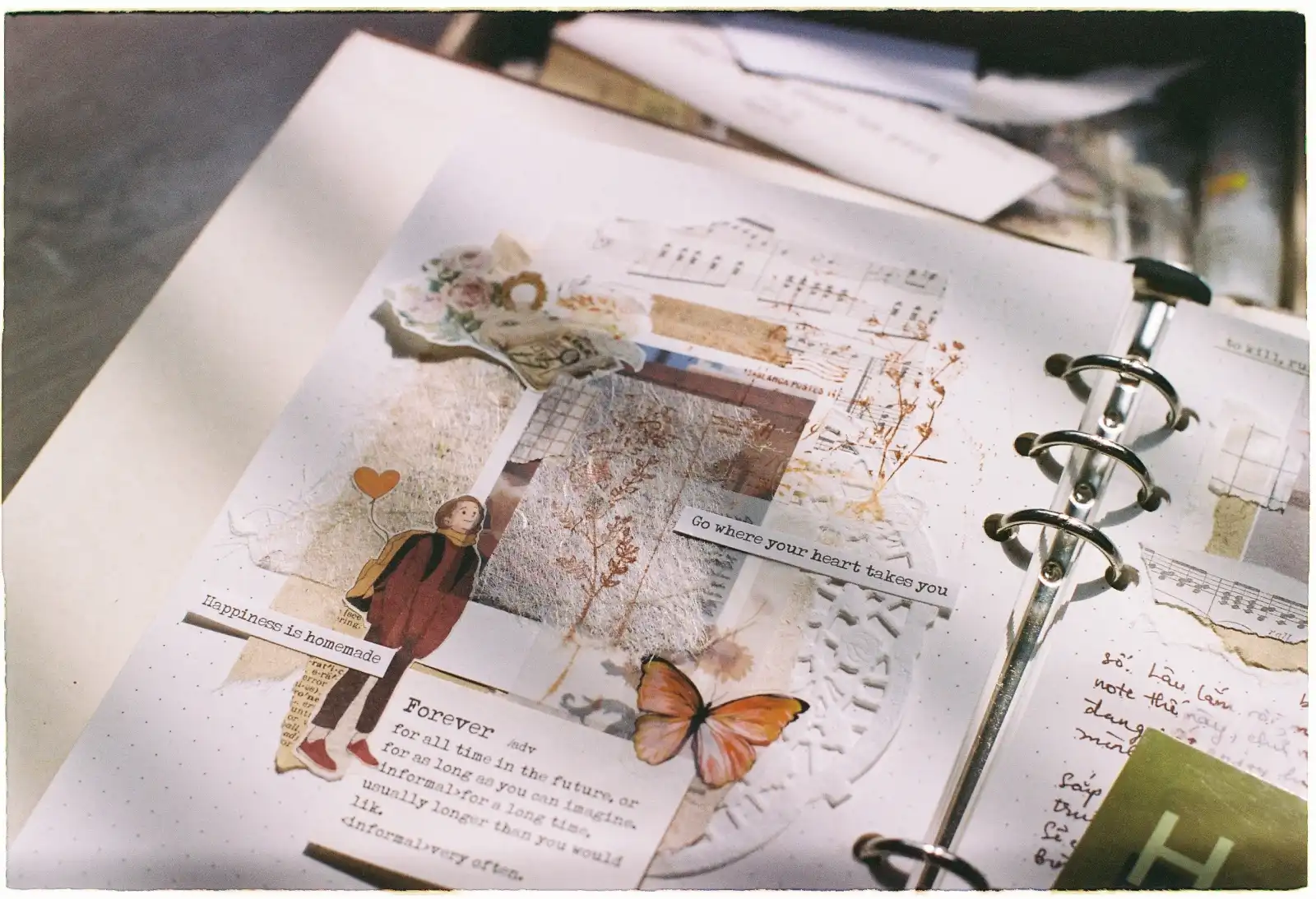 A beautifully decorated scrapbook page with vintage elements and inspiring quotes