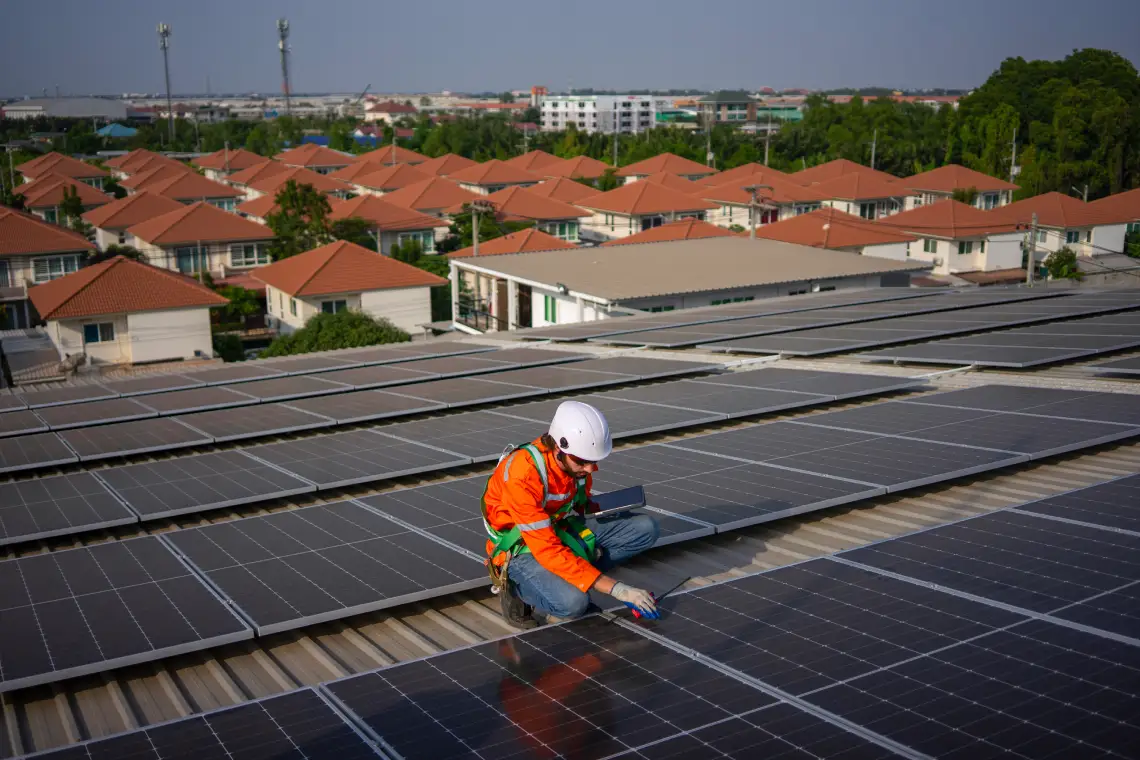 blue collar worker is inspecting solar panel